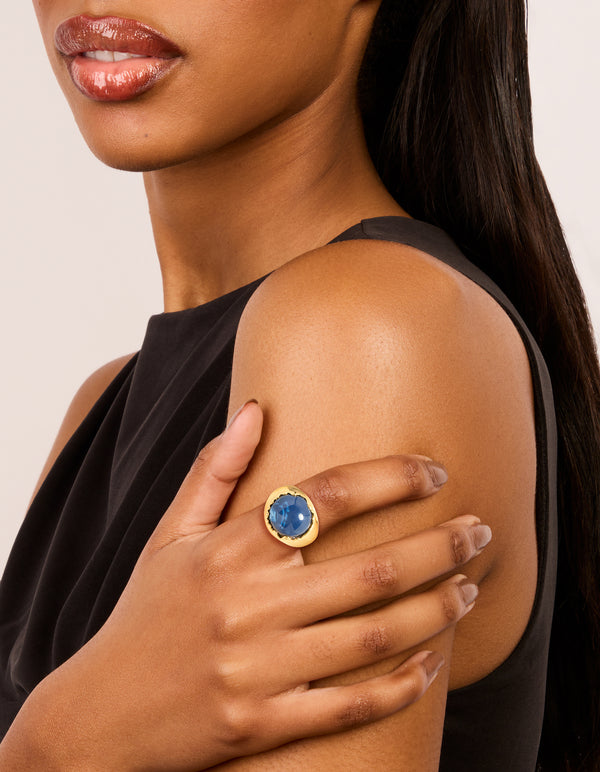 Featuring a gold plated oversized blue jewel ring with navy details on model view