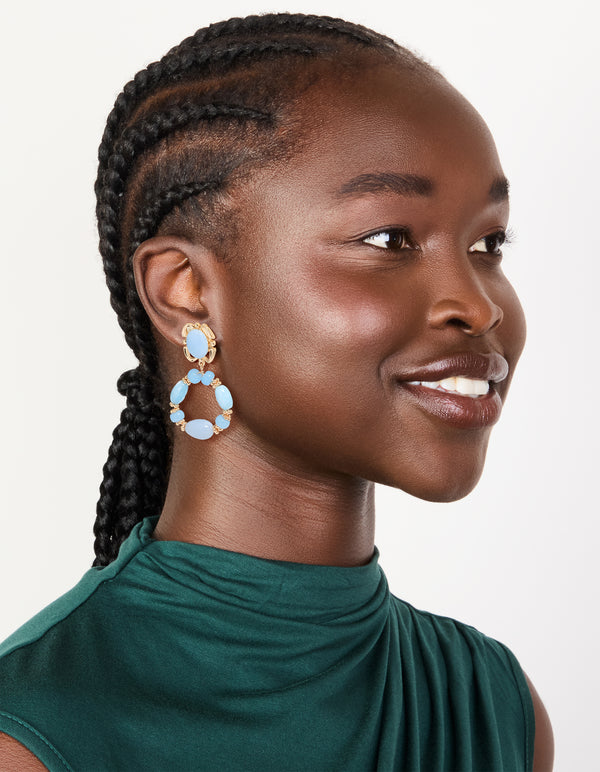 Styled gold light blue beaded oval drop earrings with on model view