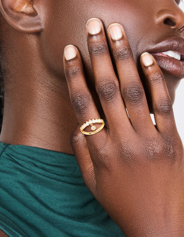 Showcasing a gold plated cubic zirconia split charm ring on finger view