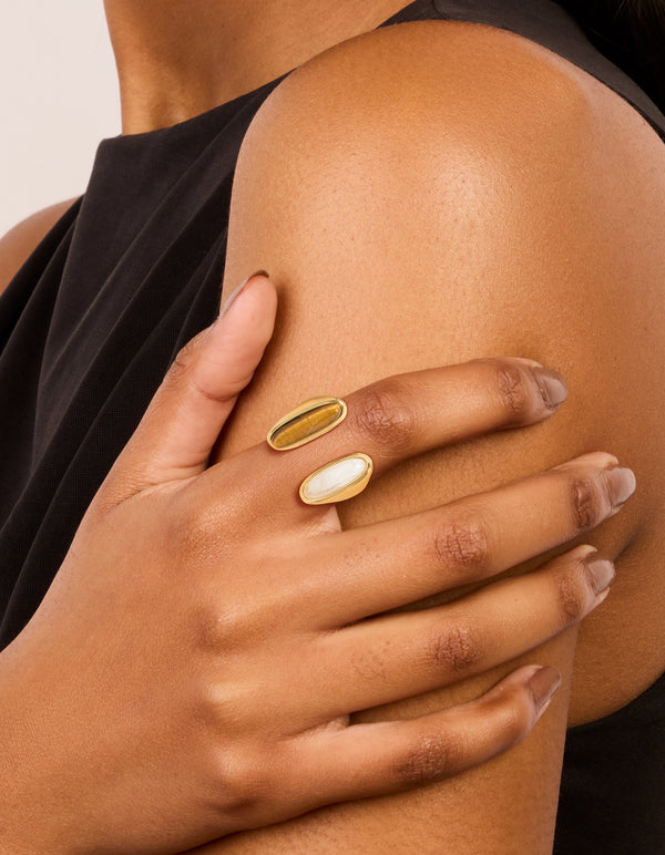 Showcasing a waterproof gold plated stainless steel open double stone ring in statement style on finger view