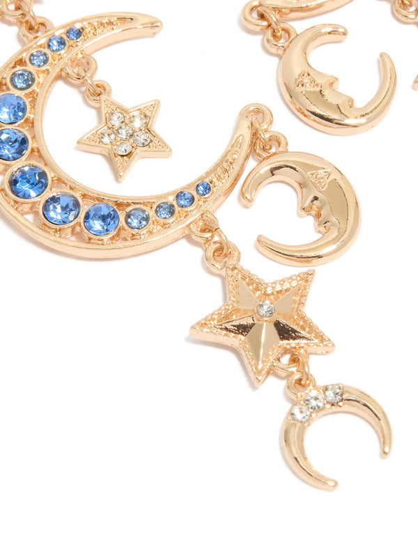 Elegant statement gold and blue diamante drop earrings with celestial charm featuring moon and star motifs close up view