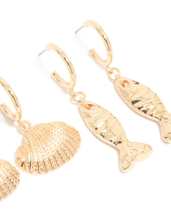 Crafted from gold sea life huggie earrings in a 3-pack featuring ocean shell and animal design post detail view