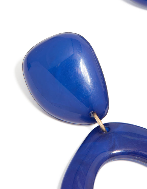 Highlighting dark blue acrylic organic square-oval drop earrings with statement style in close up view