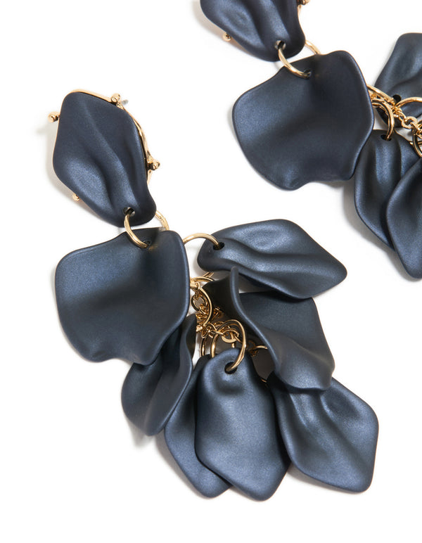 Detailed view of navy blue coated metal flower petal drop earrings highlighting gold connections in close up view