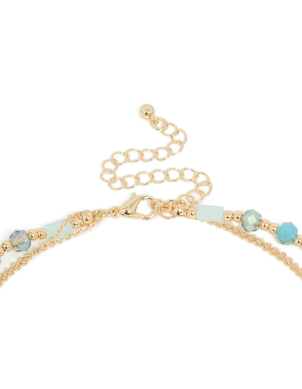Explore this layered necklace with blue beads, tassel and oval pendant in statement styling in gold clasp detail view