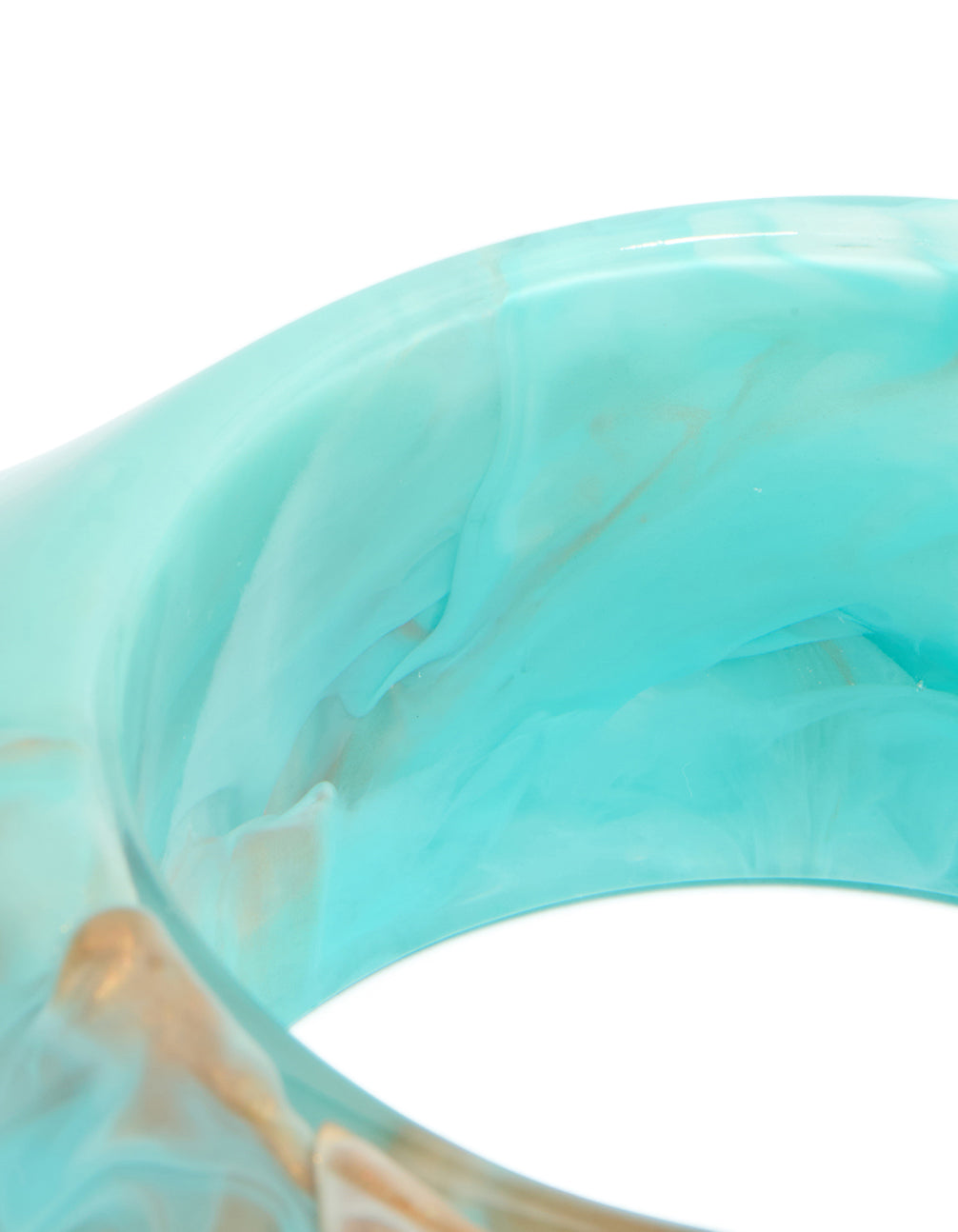 Showcasing a light turquoise and tan marbled acrylic statement bangle with chunky design close up view