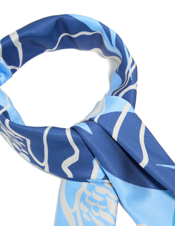 A closer look at this dark blue fabric scarf featuring grey flower outline dodger blue, navy, light blue and grey hues detail view
