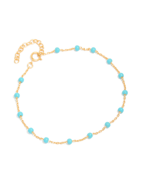 Crafted from gold plated sterling silver with blue enamel beads in turquoise station bracelet front view