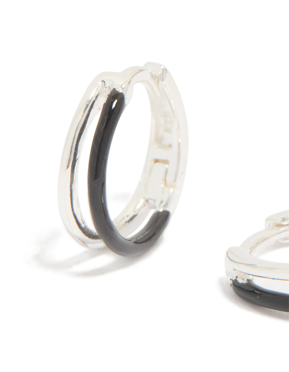 Featuring statement hoop earrings made from sterling silver with black enamel detail close up view