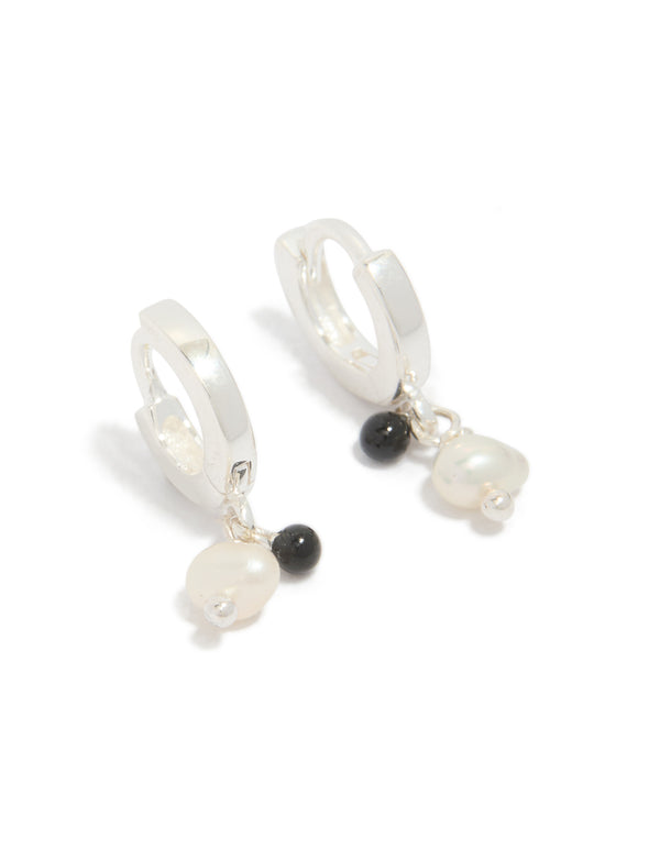 Crafted from sterling silver drop huggie earrings featuring beaded charm with pearl and black stone accents front view