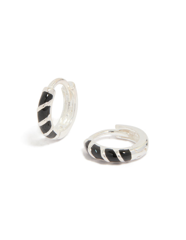Showcasing sterling silver black striped enamel huggie earrings with hoop closure front view