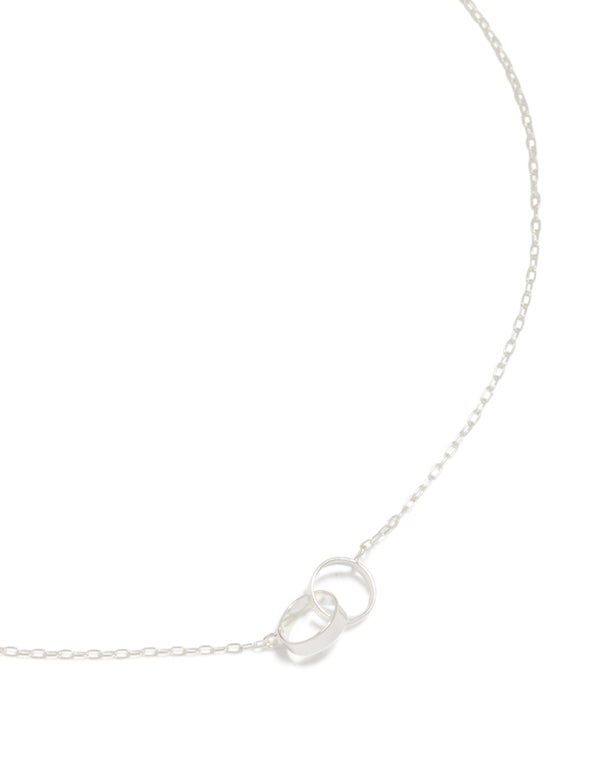 This stunning piece showcases interlocked hoops crafted from sterling silver featuring a pendant in a beautiful necklace design close up view