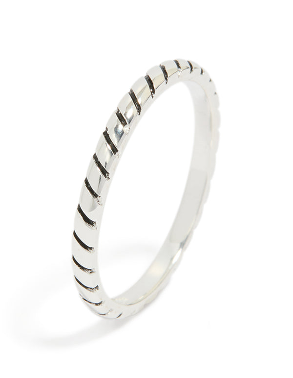 Featuring a sterling silver textured black enamel statement ring side detail view