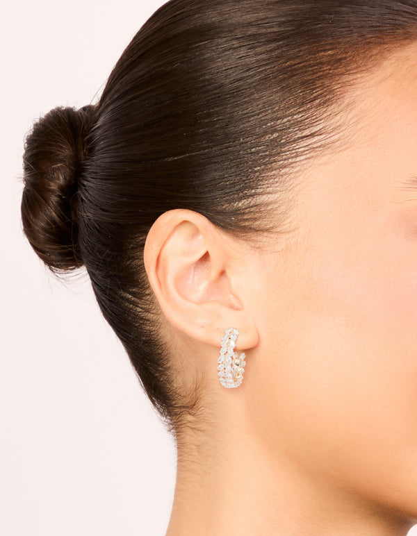 Elegant rose gold plated cubic zirconia leaf hoop earrings worn on ear displaying medium size and placement on ear view