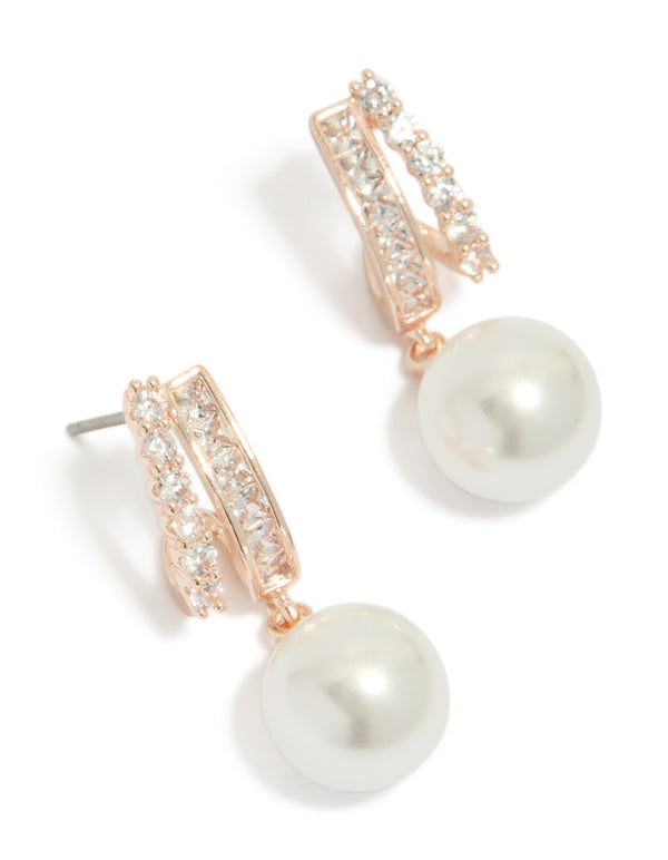 Showcasing rose gold plated cubic zirconia illusion pearl drop earrings with hoop closure in ivory front view