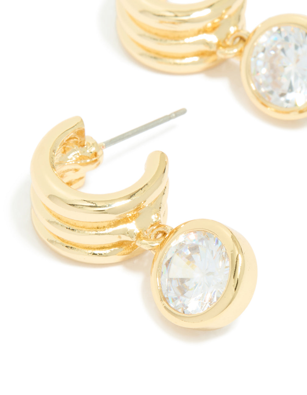 Featuring gold plated cubic zirconia bezel line huggie earrings close up view