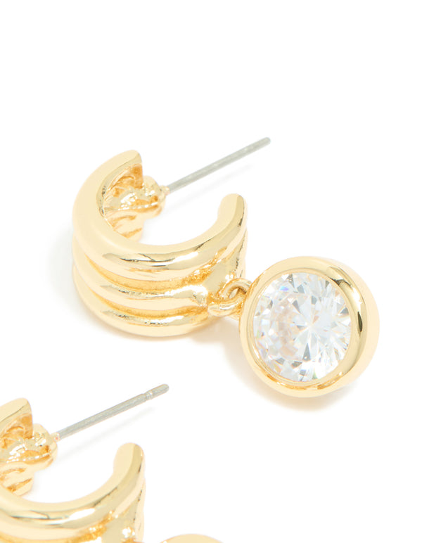 Highlighting gold plated cubic zirconia bezel line huggie earrings post detail view