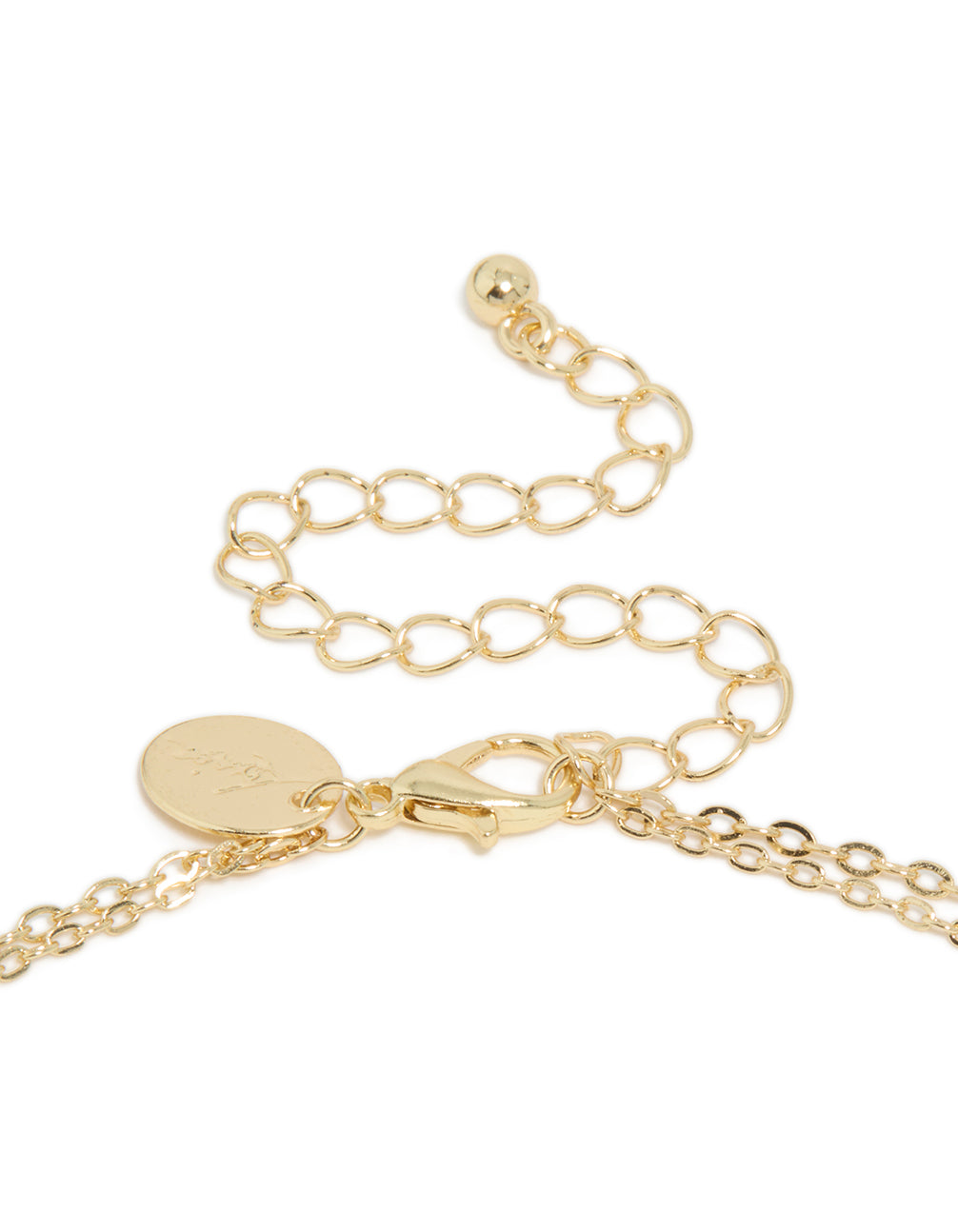 Detailed view of gold plated layered necklace clasp with pink and blue stones in statement style clasp detail view