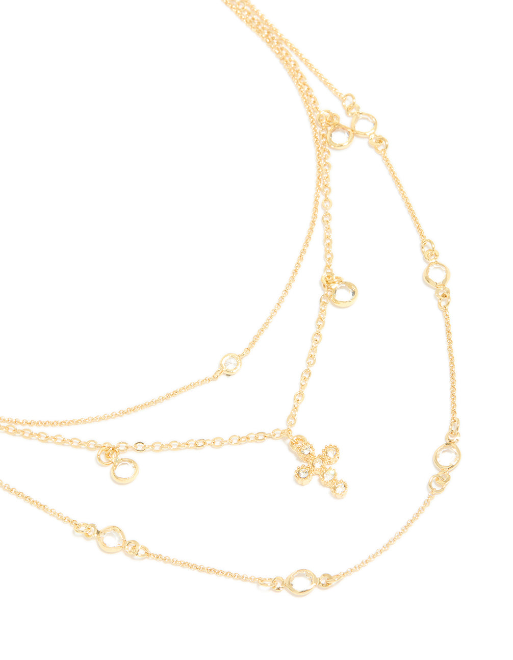 Beautifully crafted gold plated layered necklace featuring cubic zirconia bezel settings and cross pendant in statement design close up view