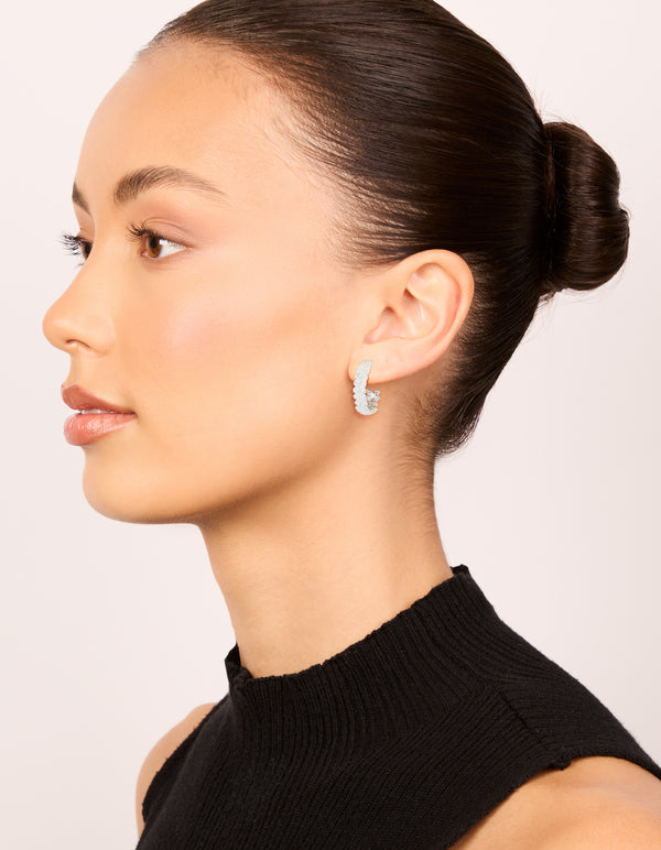 Crafted silver plated medium leaf hoop earrings featuring cubic zirconia on model view