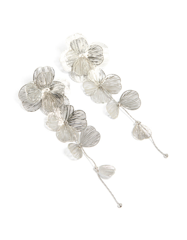 Featuring silver long floral drop earrings with featuring textured petal design front view