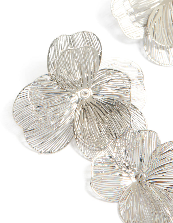Crafted from silver long floral drop earrings with featuring intricate petal texture close up view