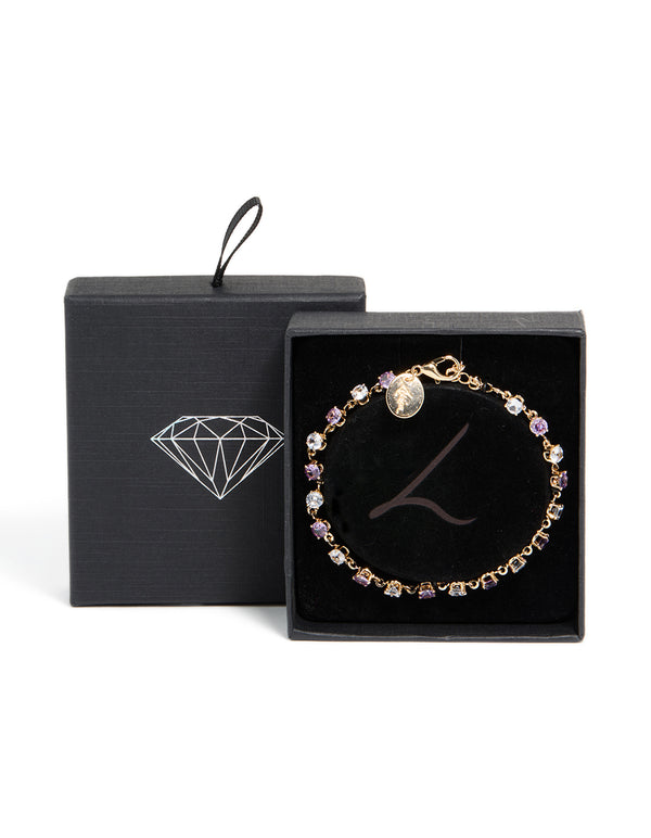 Elegant gold purple and grey cubic zirconia bracelet featuring lavender and light cyan stones front view