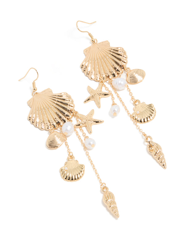 Discover these gold pearl and multi shell drop earrings featuring ocean-inspired charm details in white front view