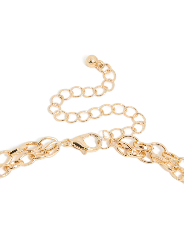 Highlighting the clasp and chain of a gold layered necklace with charms, evil-eye, heart, ocean-themed shell details, clasp detail view