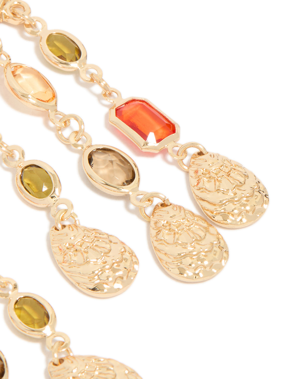Highlighting the molten texture of statement drop earrings with charm elements in blue and green diamante close up view
