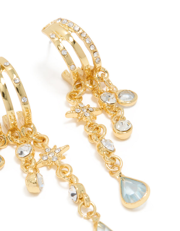 Beautifully crafted statement earrings in gold with celestial & charm accents featuring cubic zirconia and pale turquoise teardrop dangles close up view