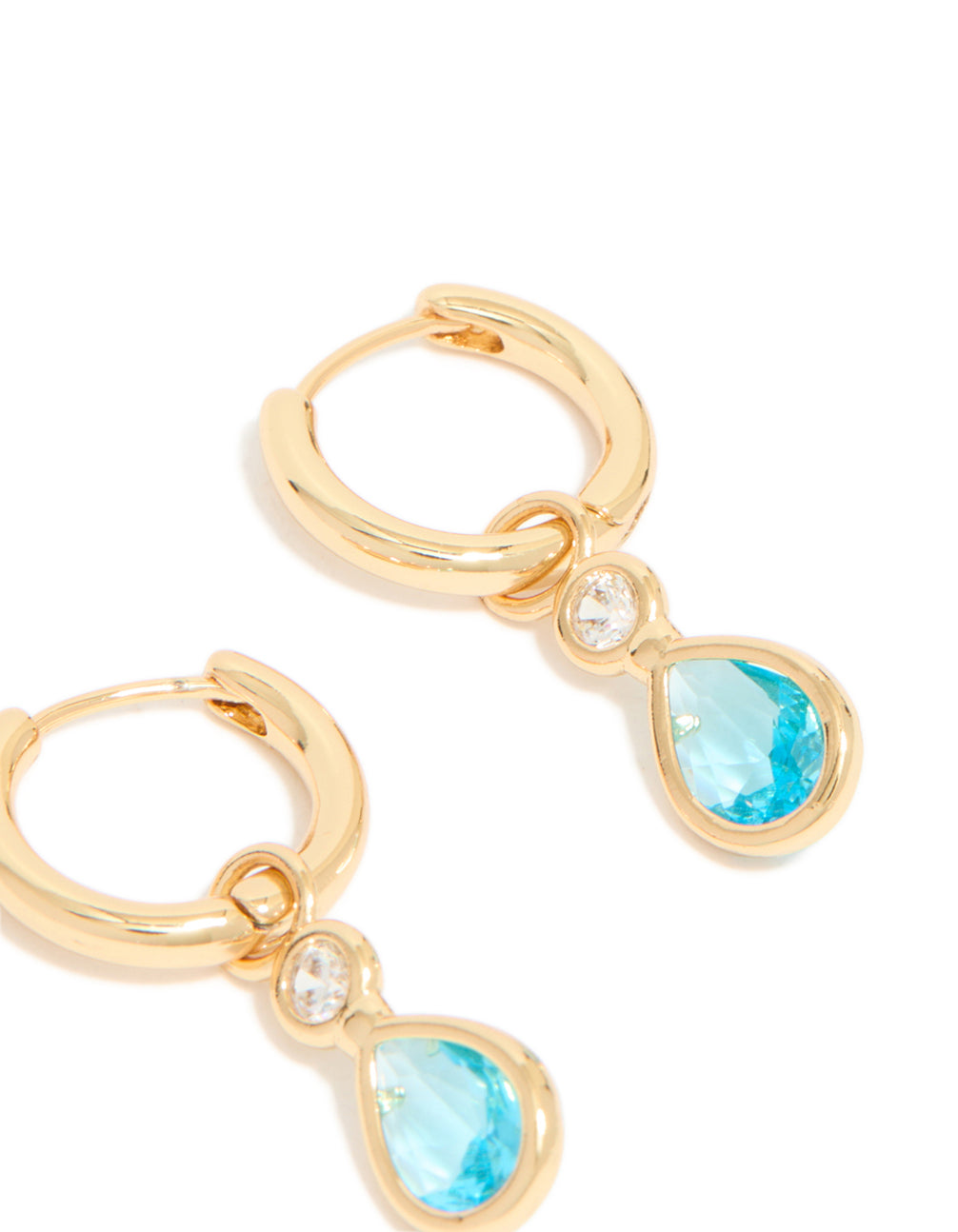 Highlighting the intricate gold plated blue cubic zirconia teardrop huggie earrings with hoop closure post detail view