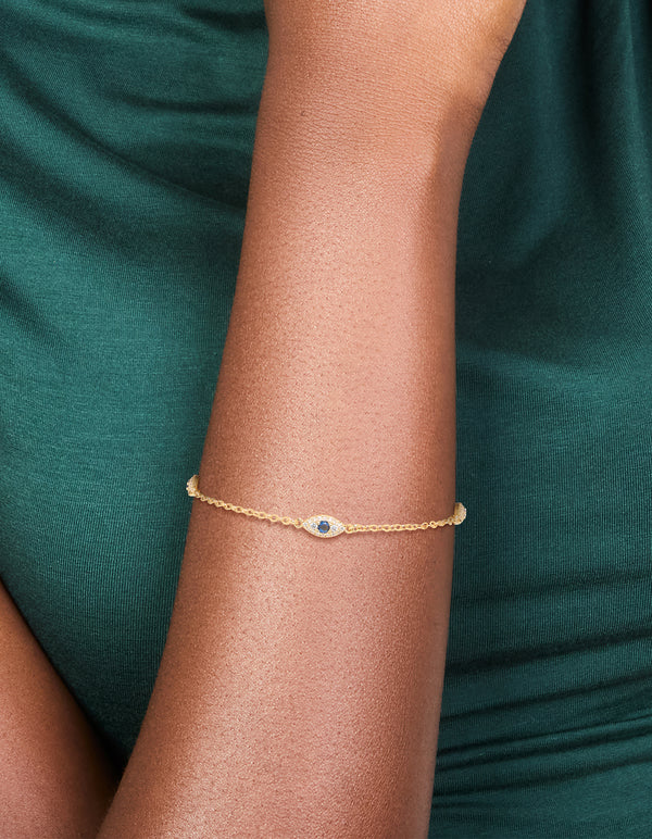 Beautifully crafted gold plated cubic zirconia evil eye trio bracelet worn on wrist view