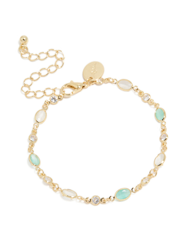 Exquisite gold plated bracelet featuring clear and blue cubic zirconia in oval stone front view