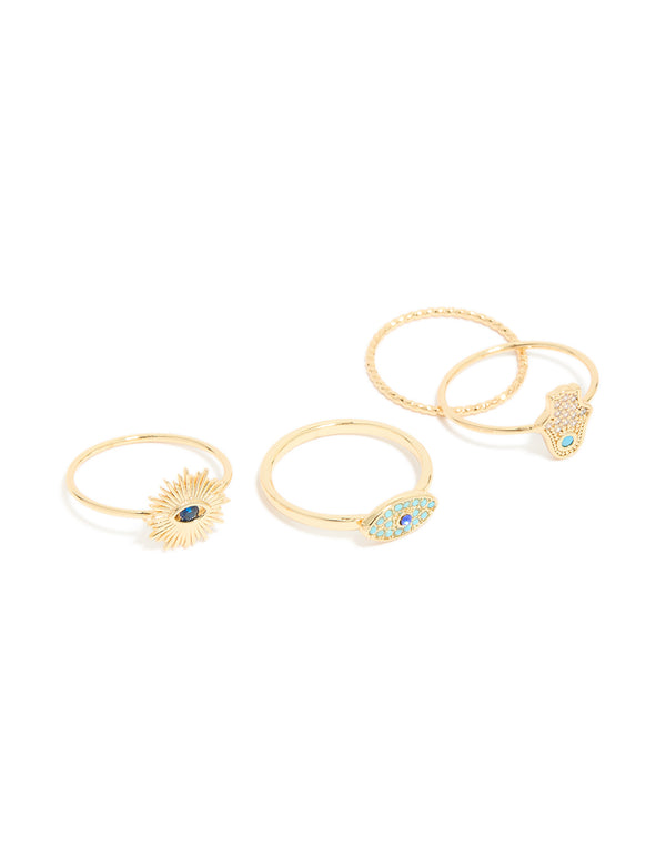 Featuring a gold-plated cubic zirconia evil eye and hamsa hand rings 4-pack with celestial sun motifs, crystal accents, and statement-style design, front view