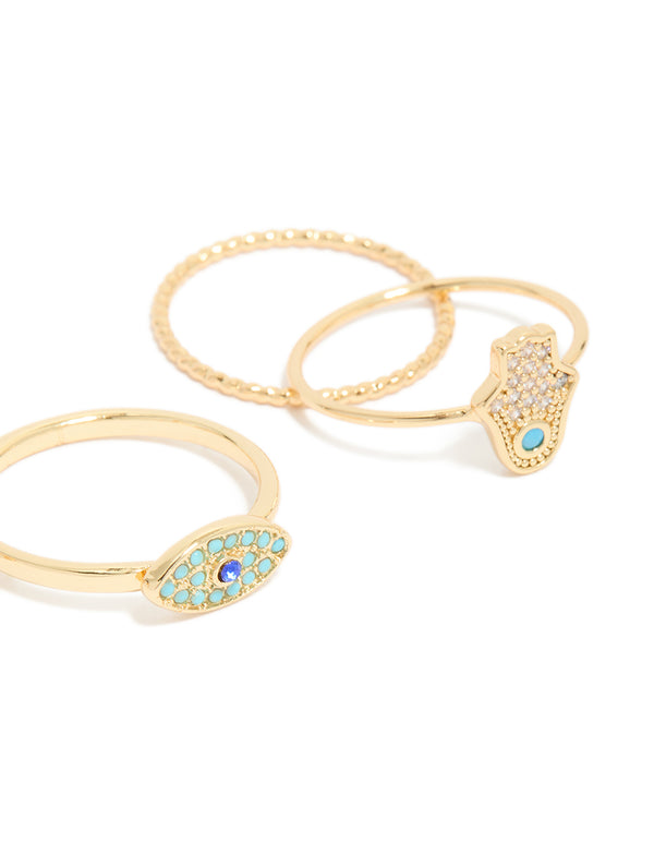 Crafted from gold plated cubic zirconia evil eye and hamsa hand rings 4-pack with celestial sun motifs, crystal accents, and statement style close up view