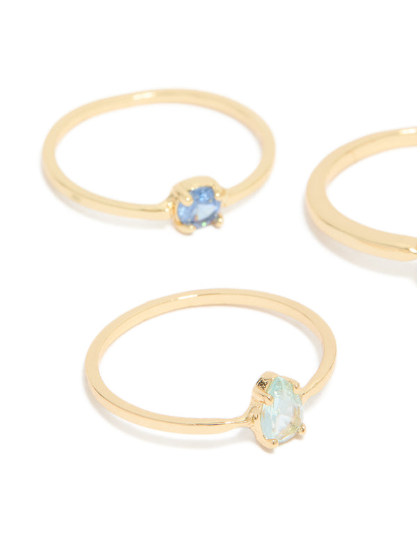 Featuring gold-plated stackable ring set featuring heart, round, and oval shaped blue cubic zirconia stones accents close up view