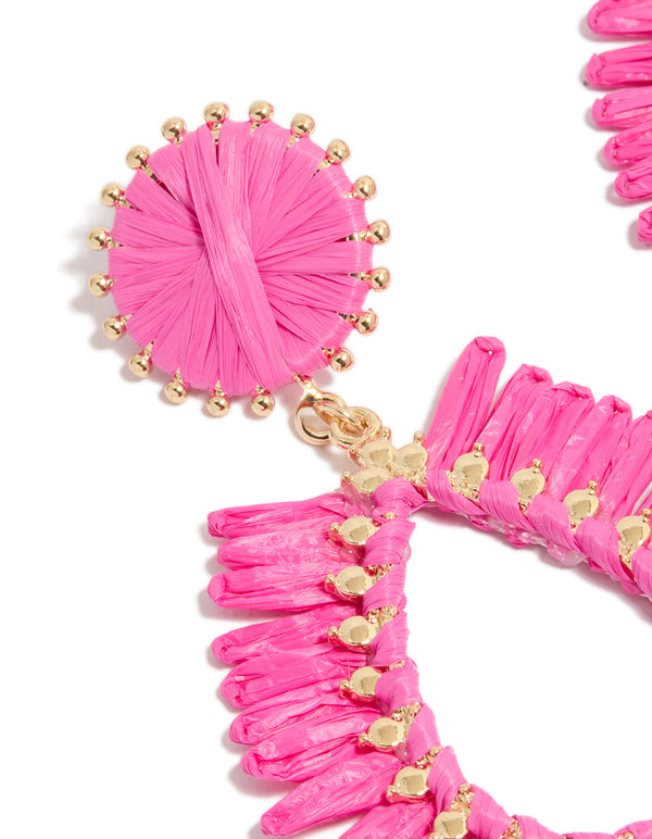 Discover statement gold hot pink raffia oval drop earrings close up view