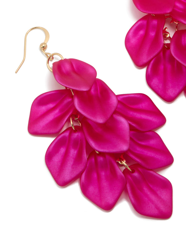 Featuring fuchsia pink coated metal petal drop statement earrings with gold hardware close up view