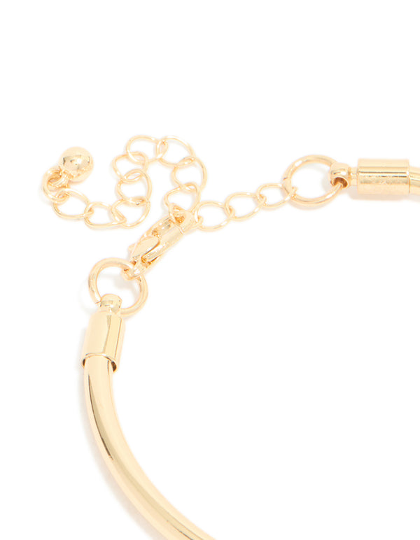 Highlighting the gold heart and black stone charm bracelet with balls, coin and pearl features in closure detail view
