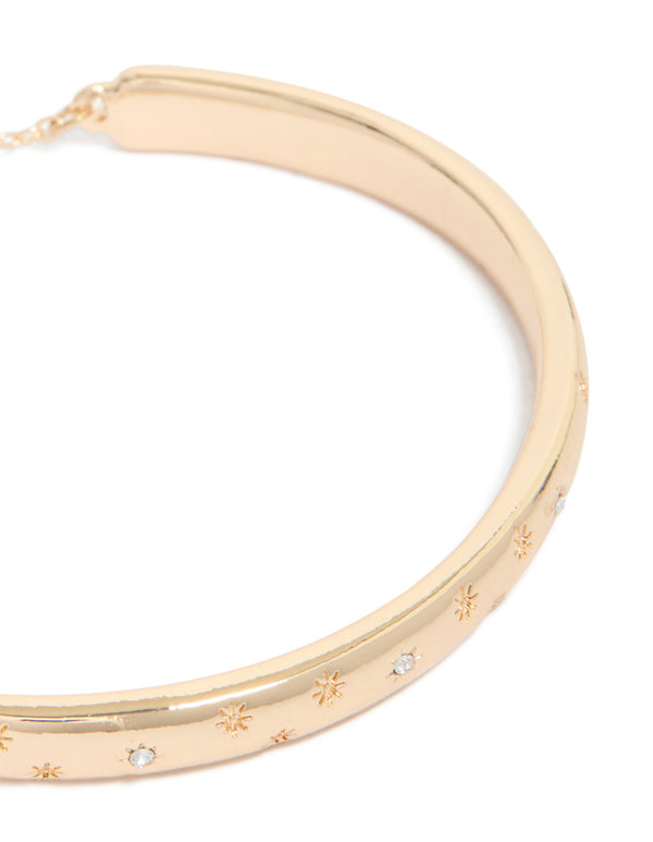 Elegant gold celestial diamante toggle bangle in close up view