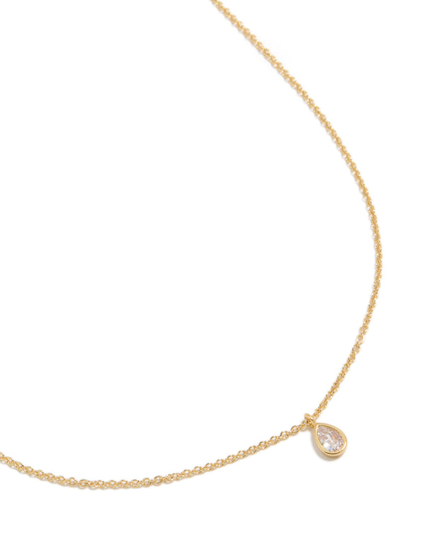 Showcasing a gold plated April birthstone necklace featuring a cubic zirconia pendant in a dainty statement style, close up view