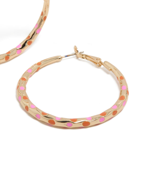 Featuring large thin hoop statement earrings crafted from enamel with dotted pattern in gold, pink, and coral post detail view