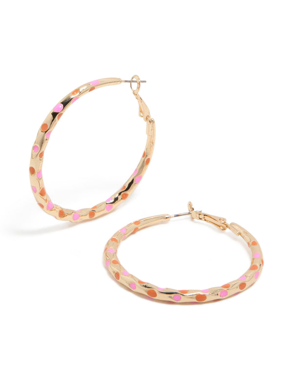 Featuring large statement hoop earrings with enamel dotted design in pink and orange on thin closure front view