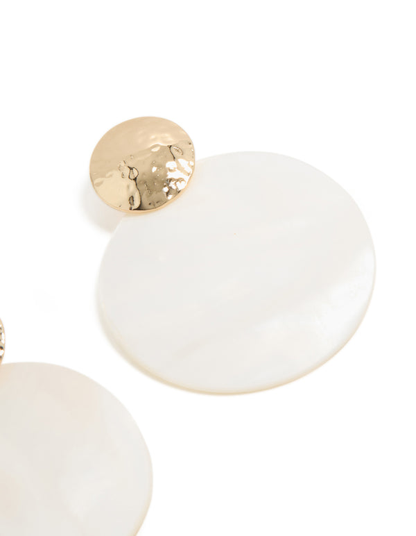 Presenting statement drop earrings crafted from hammered gold and white genuine shell post detail view