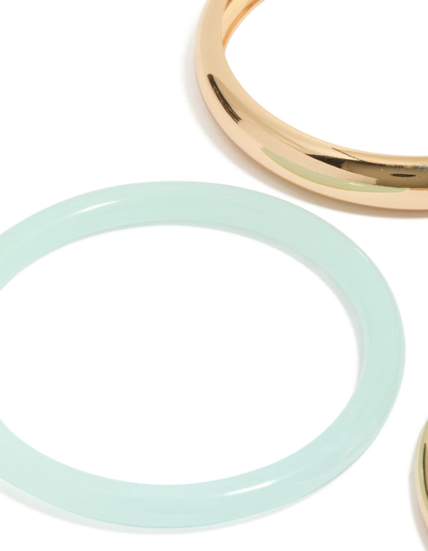 Showcasing gold and blue acrylic stackable bangle bracelets in a 4-pack close up view