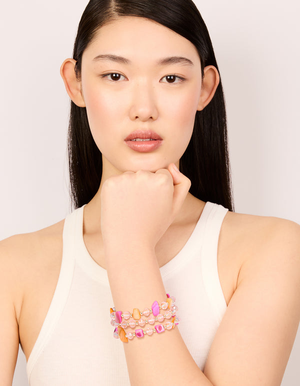 Designed with beads in pink, brown and gold, this stretch bracelet in a 3-pack is displayed on model view