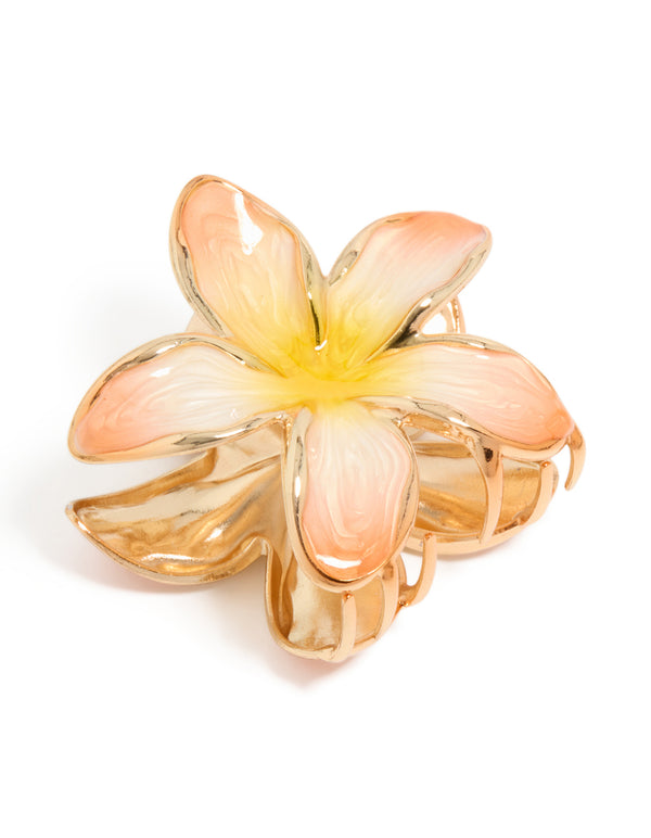 Showcasing a floral enamel peach and yellow frangipani claw clip in gold front view
