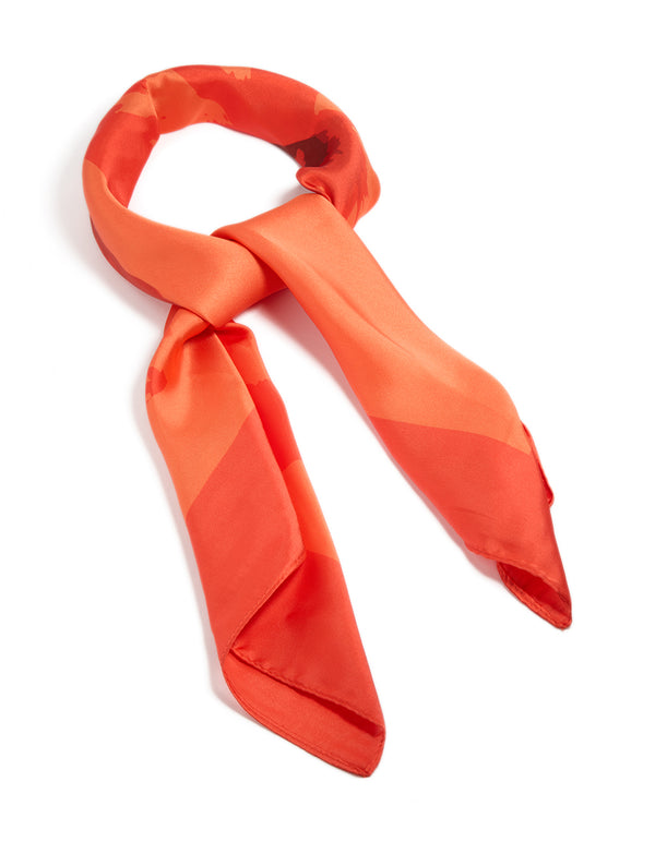 Showcasing an orange fabric scarf with double hibiscus floral print in coral, tomato, and dark orange tones, side view
