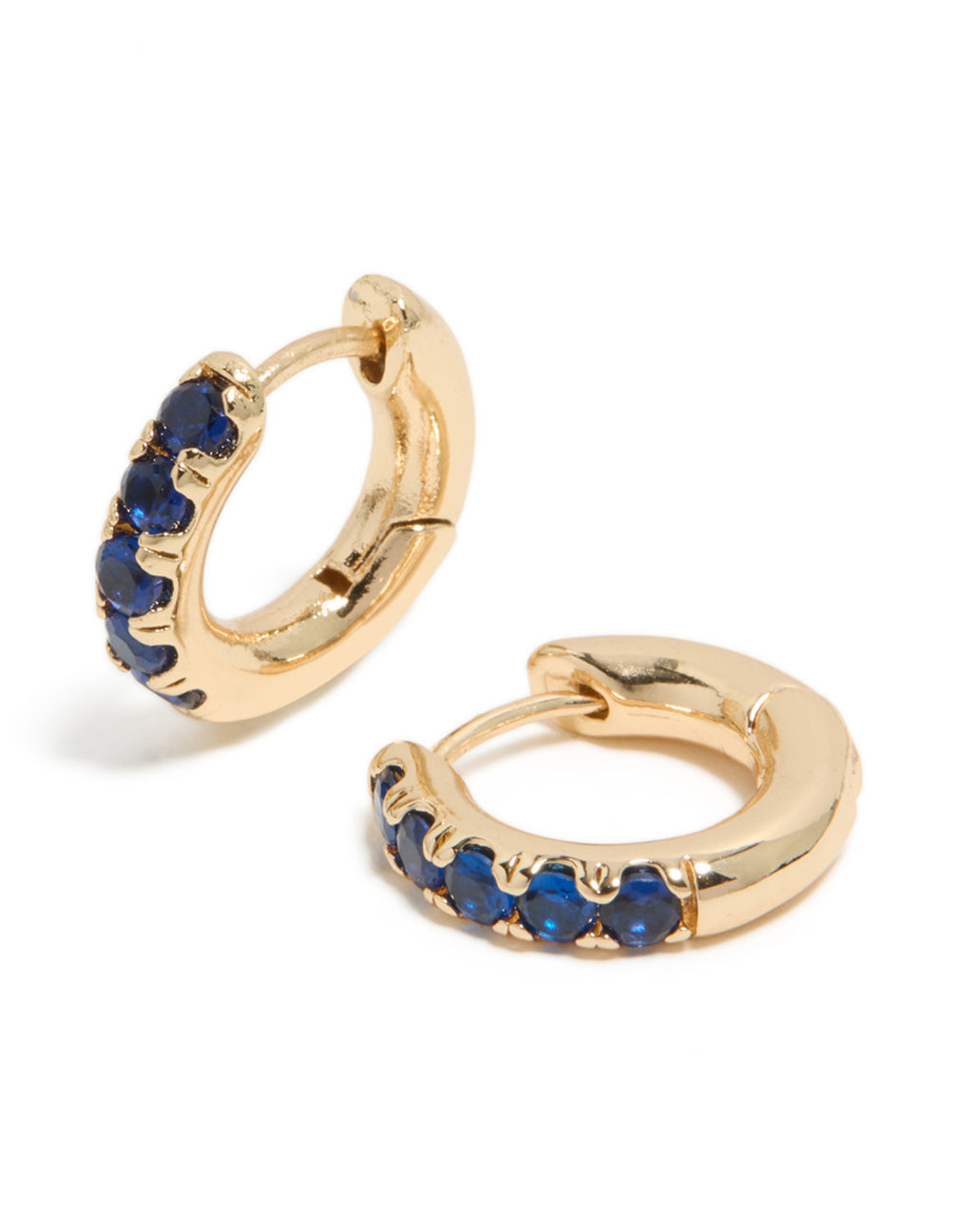 Discover small huggie clicker earrings featuring cubic zirconia in gold with dark blue accents with a front view